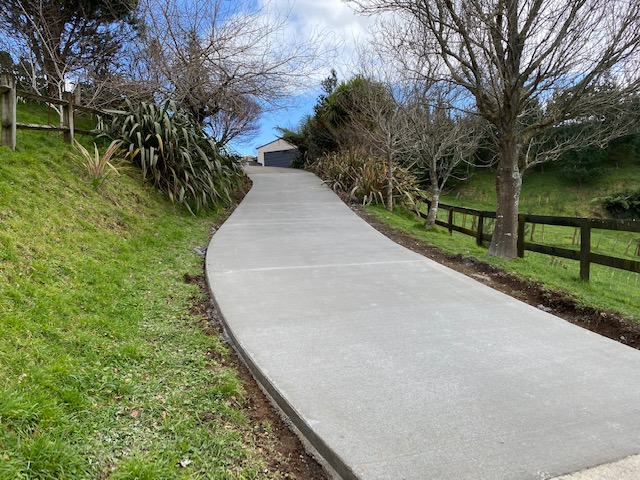 New concrete driveway on a rural hillside